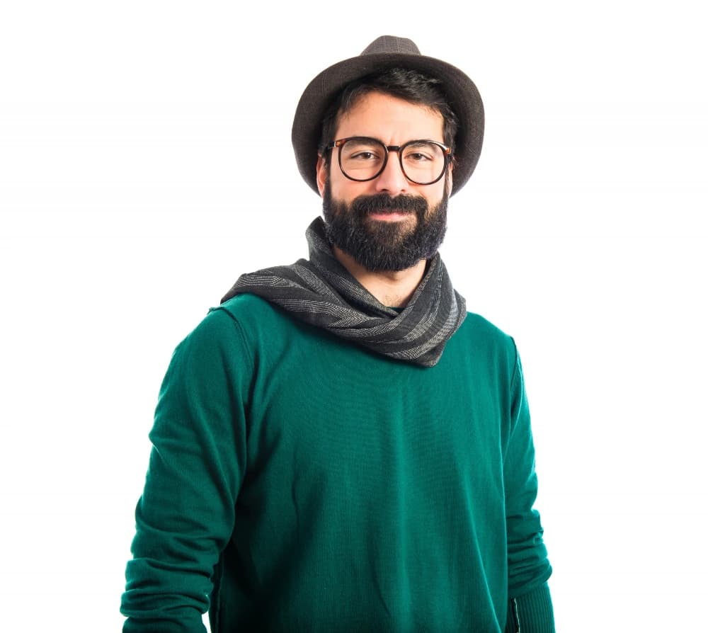 Arjun Mehta with arms crossed against a dark teal backdrop